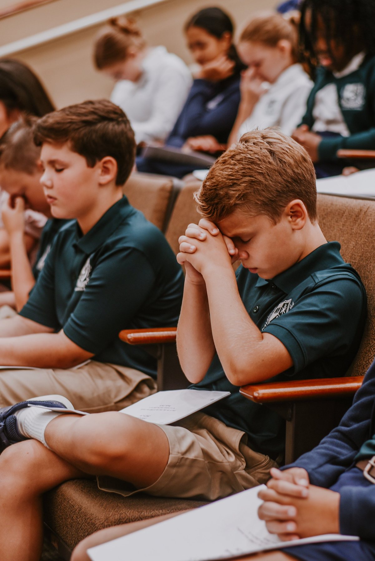 Evergreen students bow their heads in prayer.